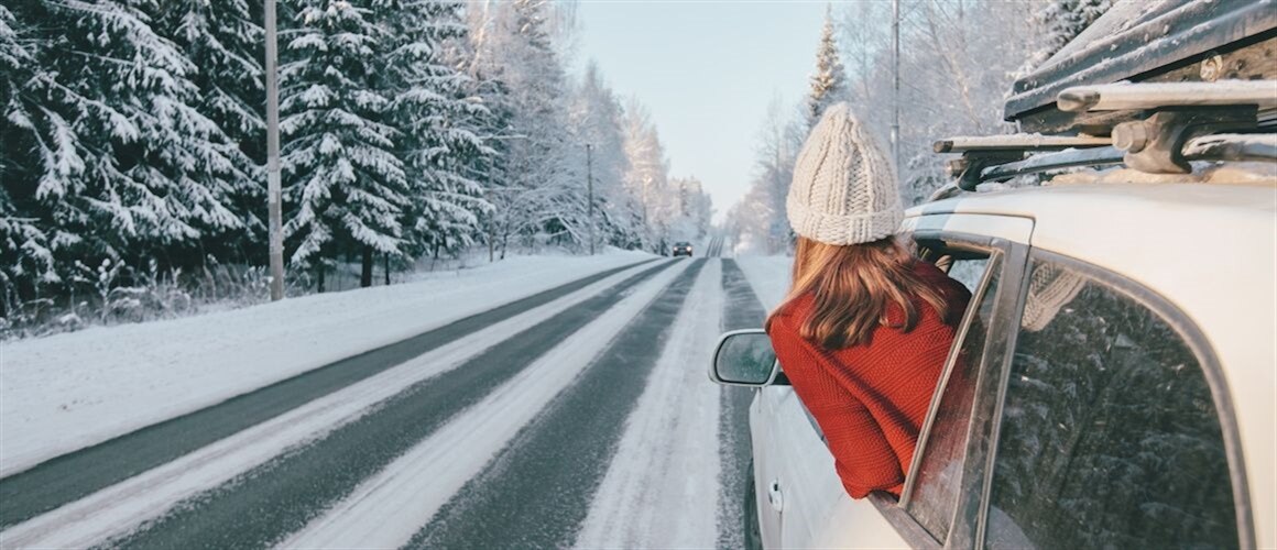 Image of girl looking out driver car window in winter.