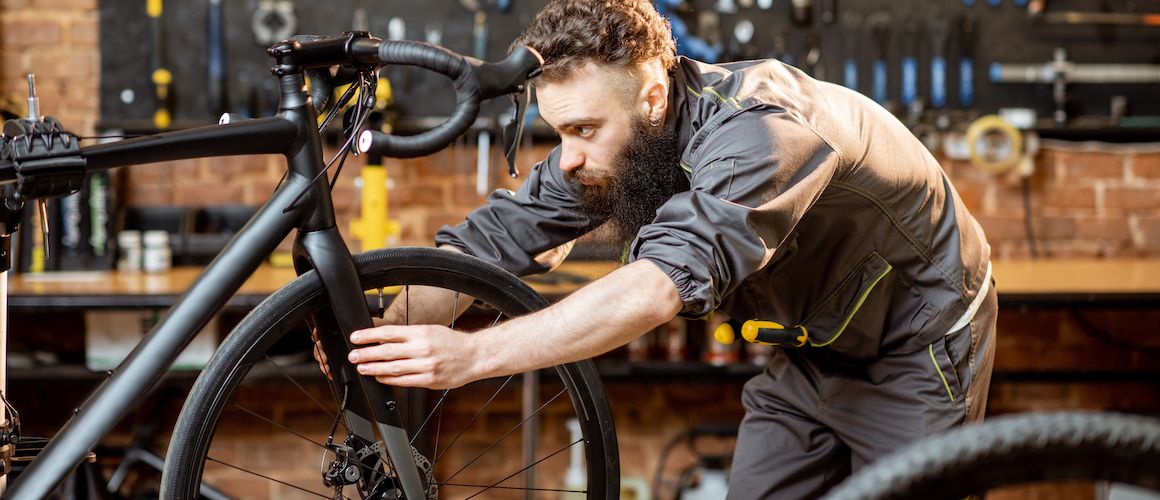 Image of business owner putting together bike.