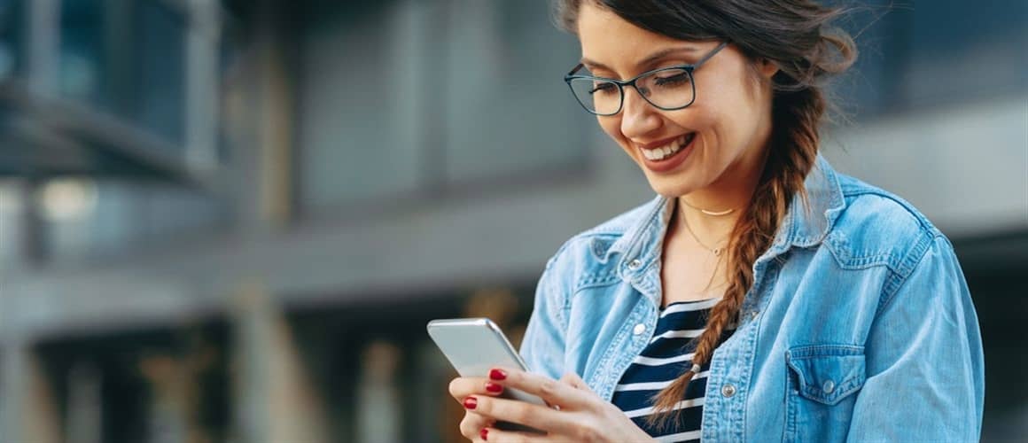Woman looking down, reading her phone