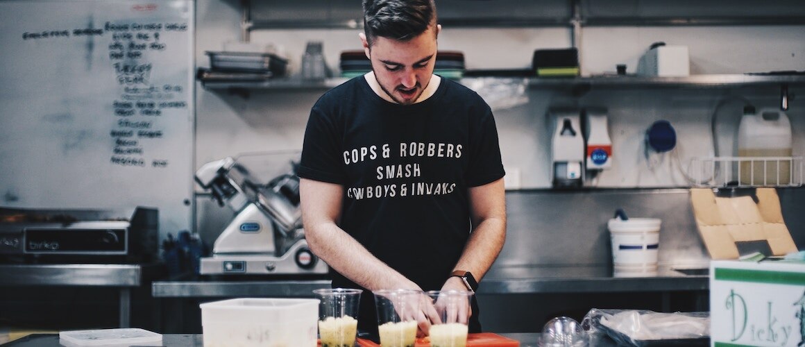 Image of small business owner preparing food.