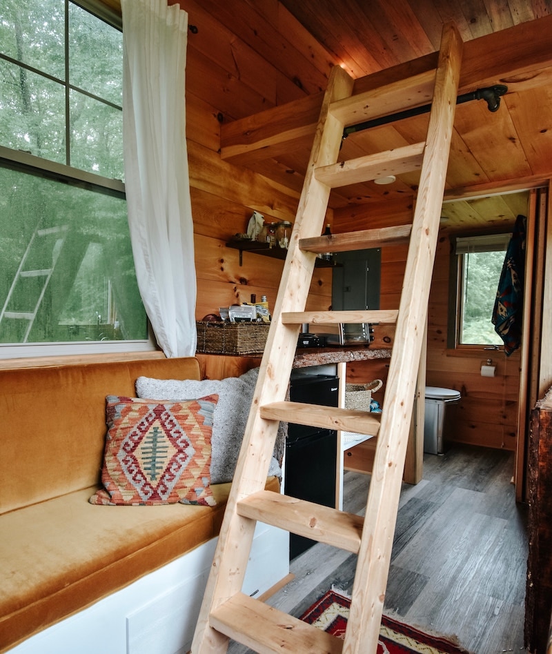 Tiny home, cozy room layout with ladder to upstairs.