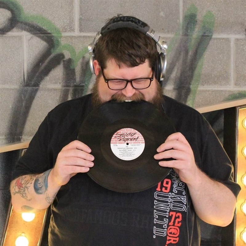 Image of Team Member Norm biting into a record.