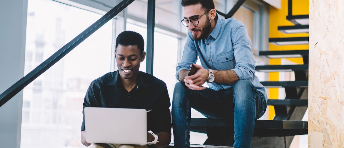 Image of coworkers comparing their investments