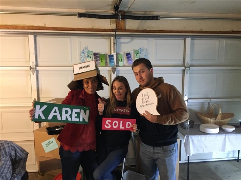 Image of friends holding up signs for photo.