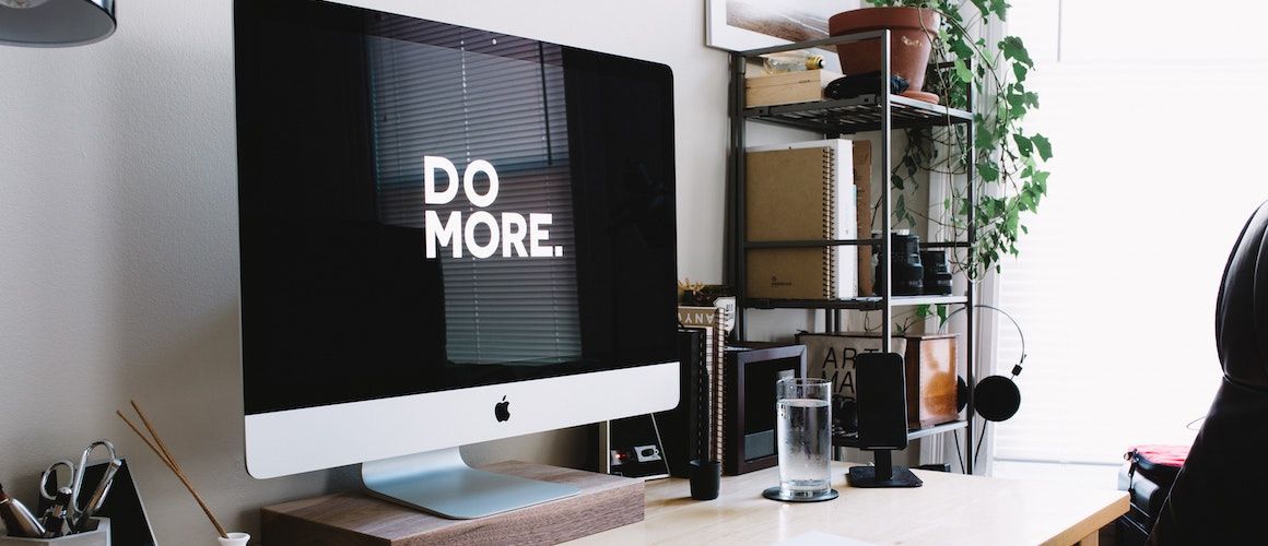 Image of computer desktop with "Do More." screensaver.