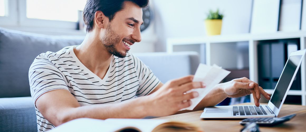 Man in striped shirt evaluating papers