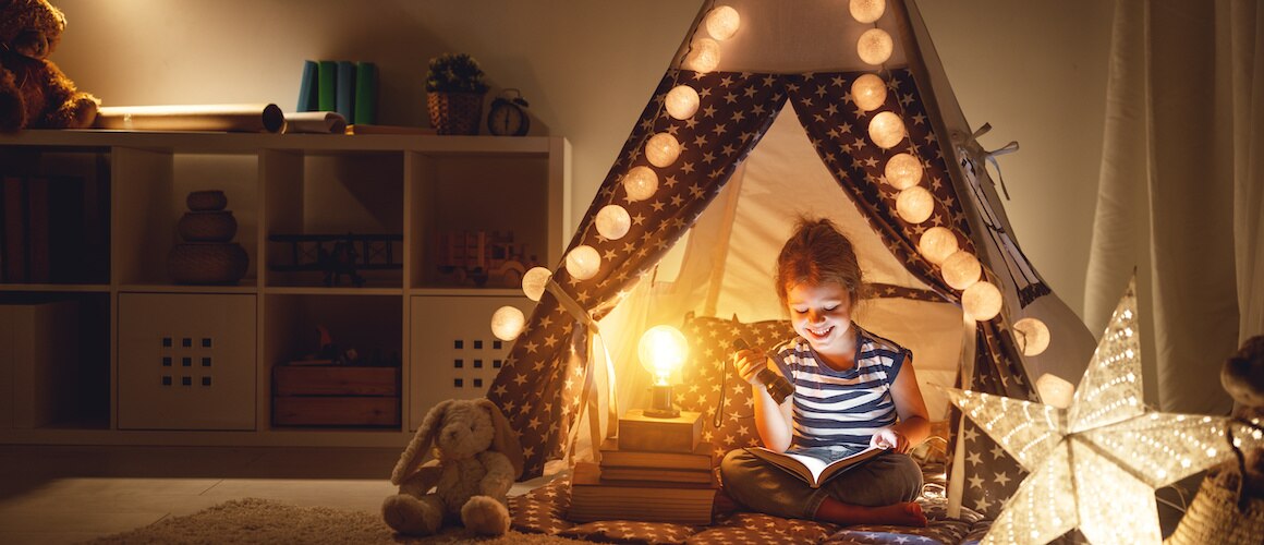 Image of girl reading in her playroom.