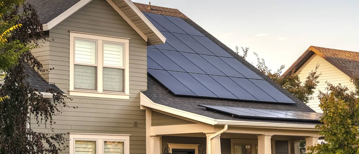 Image of solar panels installed on top of modern home roof.