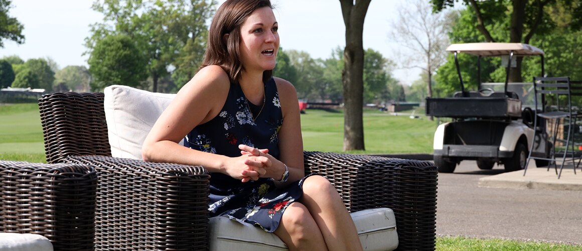 Image of hospitality and event manager being interviewed on lawn furniture.