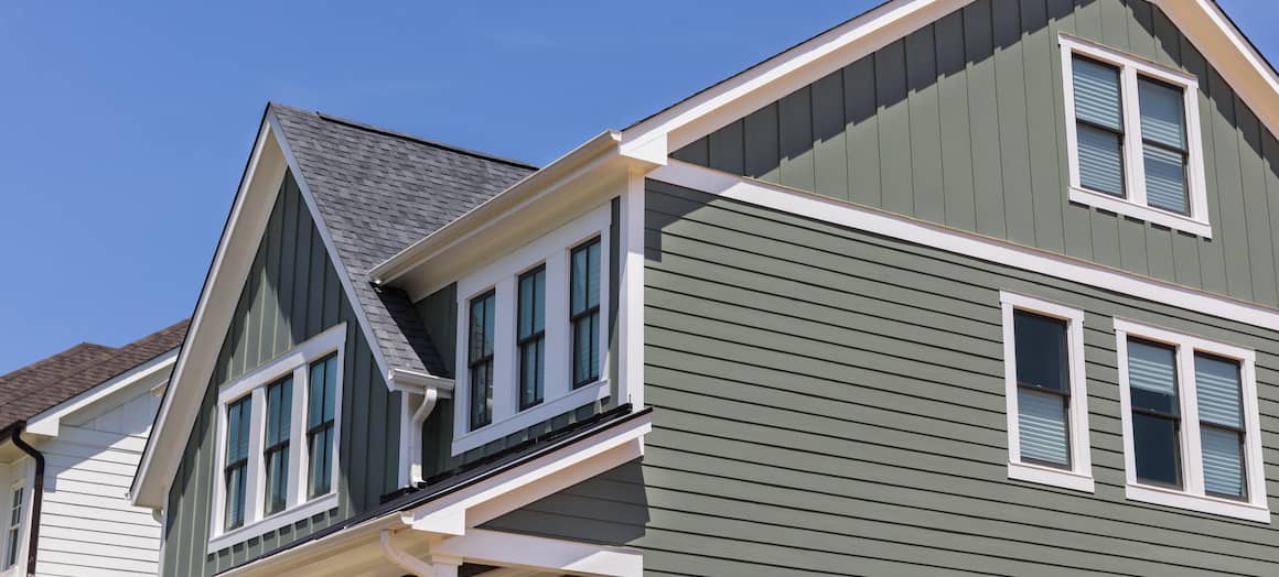 angled view of green two story house