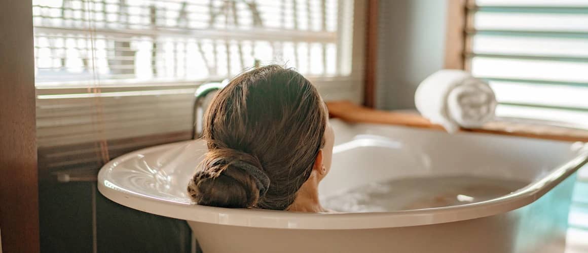 Image of woman enjoying newly remodeled bathtub.