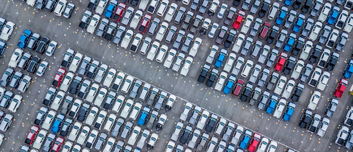 Bird's eye view of many cars lined up at a port.
