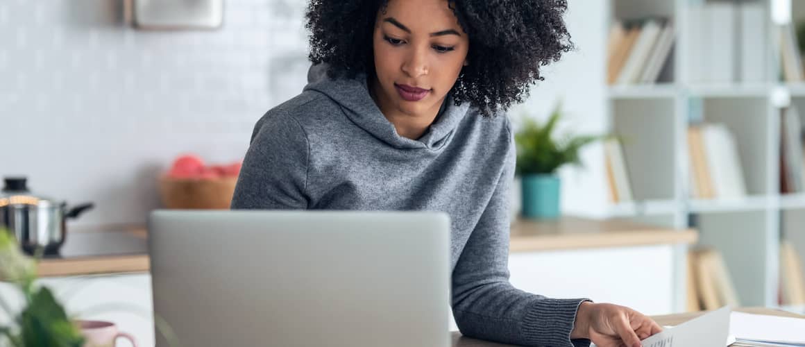 Woman searching on laptop for where to sell her car.