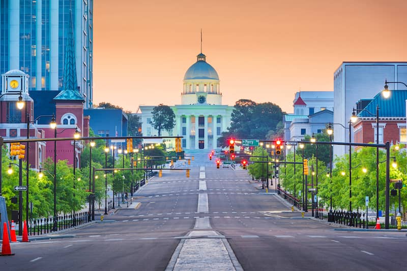 View down a street in Montgomery, Alabama, with the state Capitol at the end of the street.