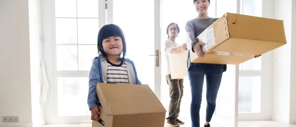 Asian family packing boxes and ready to move houses.