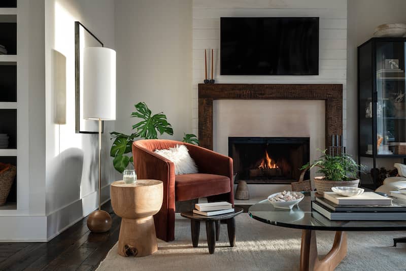 Living room with organic elements like rustic wood side table and houseplants.