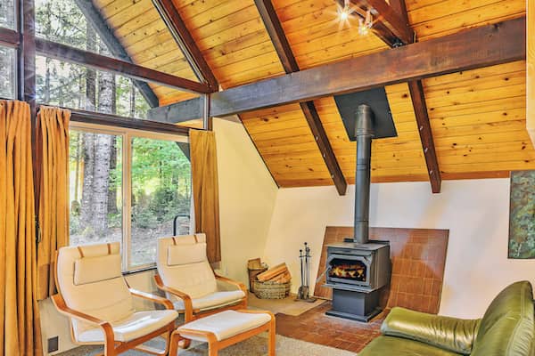 Rustic armchairs and stove in room.
