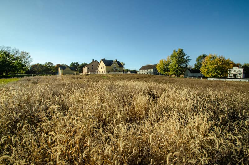 Field with houses along the horizon line in Urbandale, Iowa.