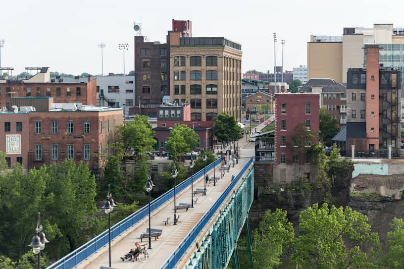 Large Blue Sidewalk Bridge With Vintage Brick Buildings