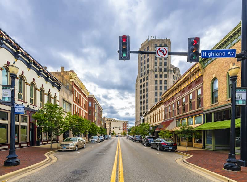 At Stop Light On A Brick Street With Shops