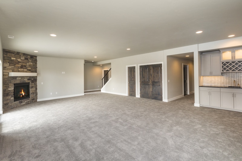 Carpeted living room with fireplace.