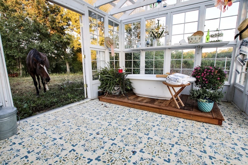 Luxury outdoor bathtub with tile stenciling.