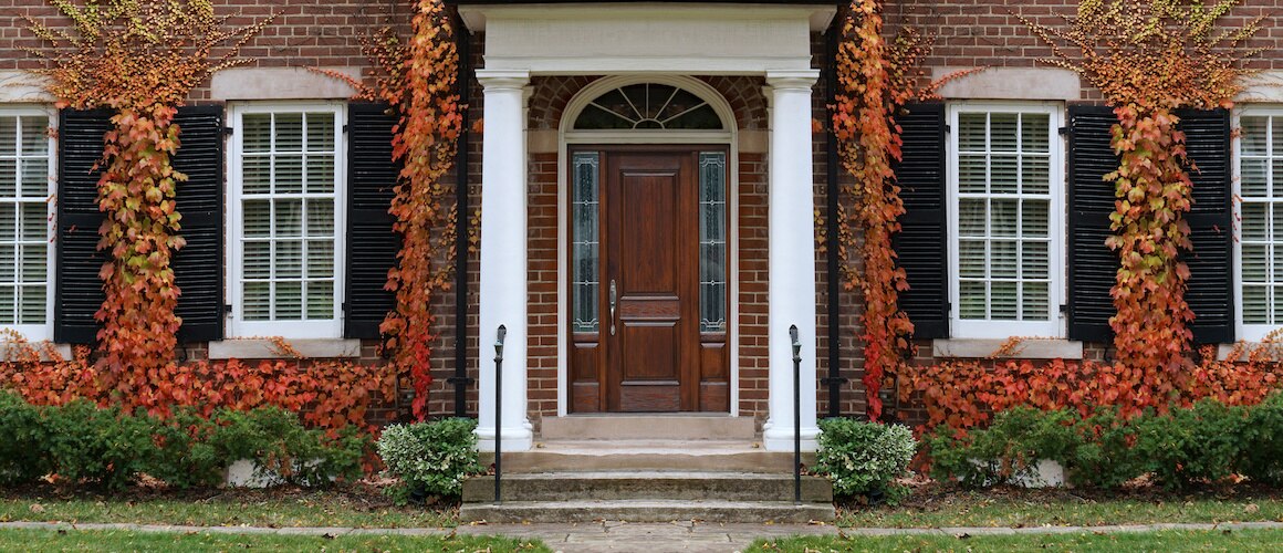 Traditional brick home with ivy.