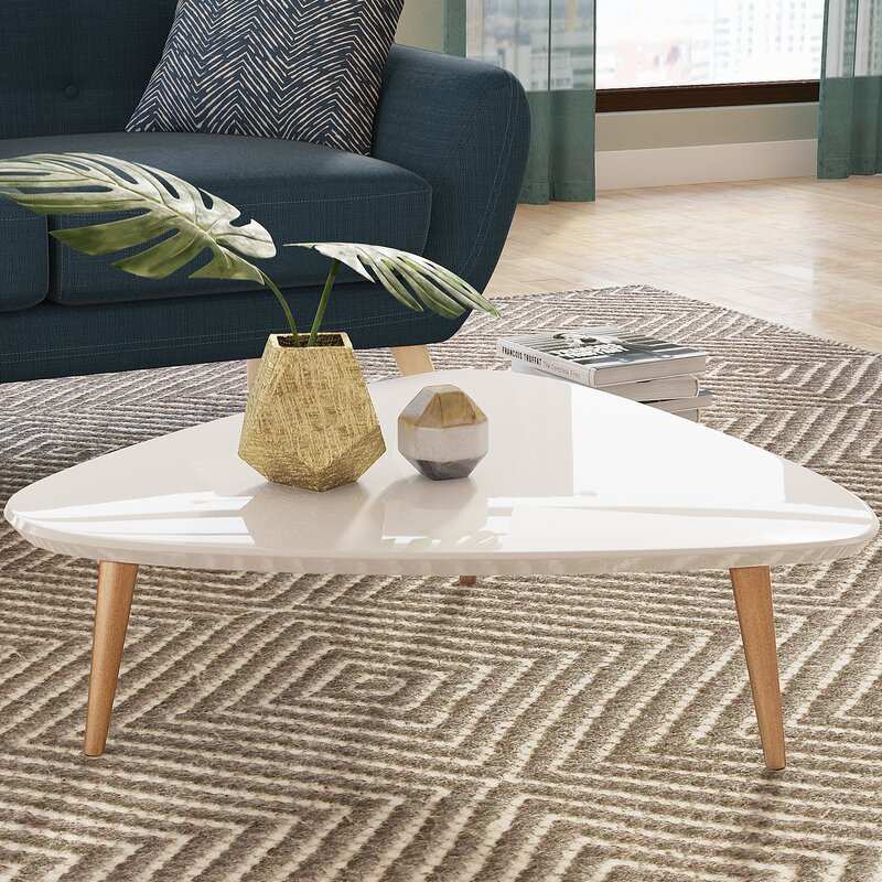 White coffee table with oak legs on a chevron rug