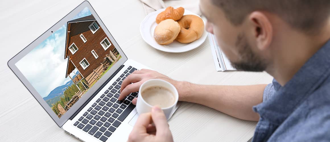 man searching for home with coffee in hand