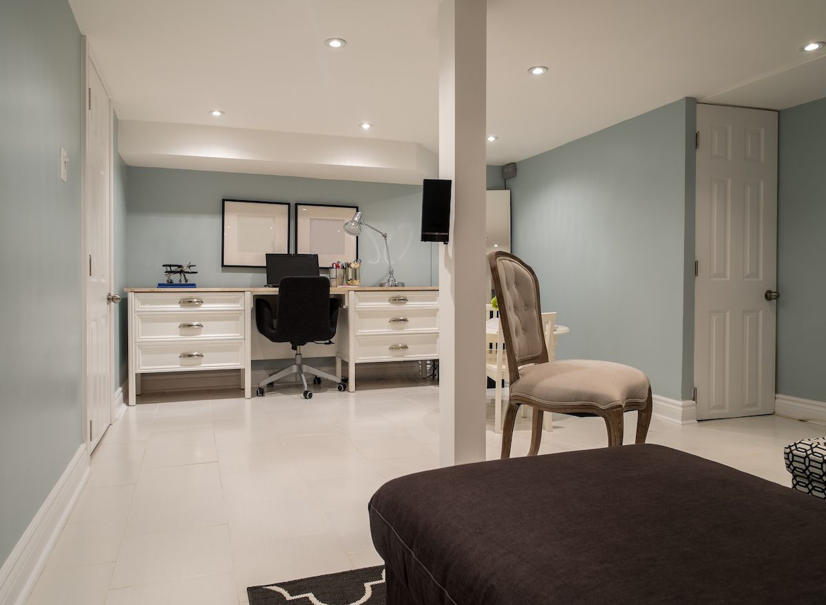 Home office with large desk in basement.