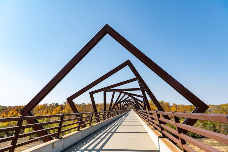 Concrete bike trail with alternating angled geometric archways.