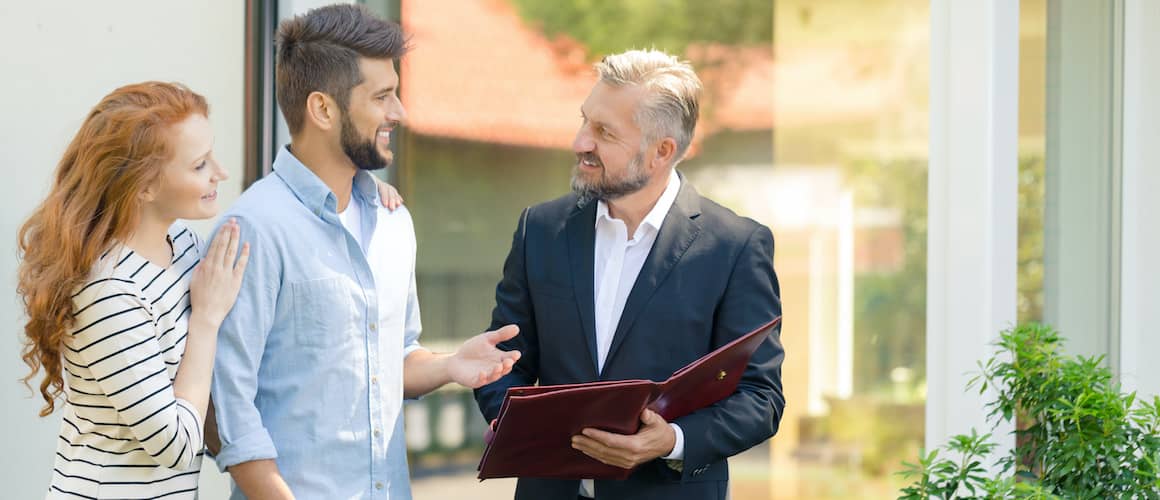 couple speaking with real estate agent