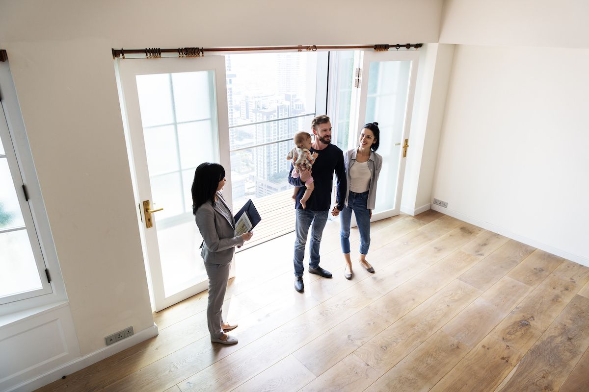 Couple house hunting with their child.