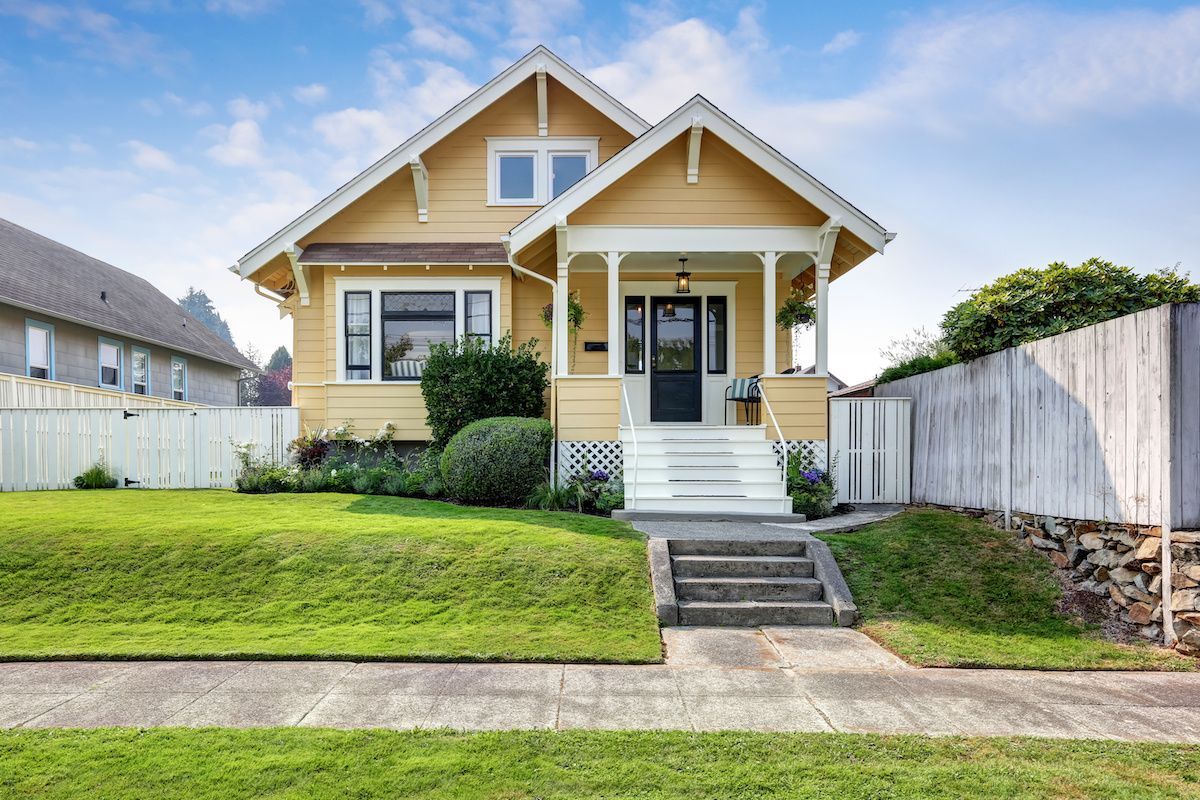 Yellow craftsman style home.