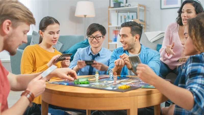 Group of friends playing board game.