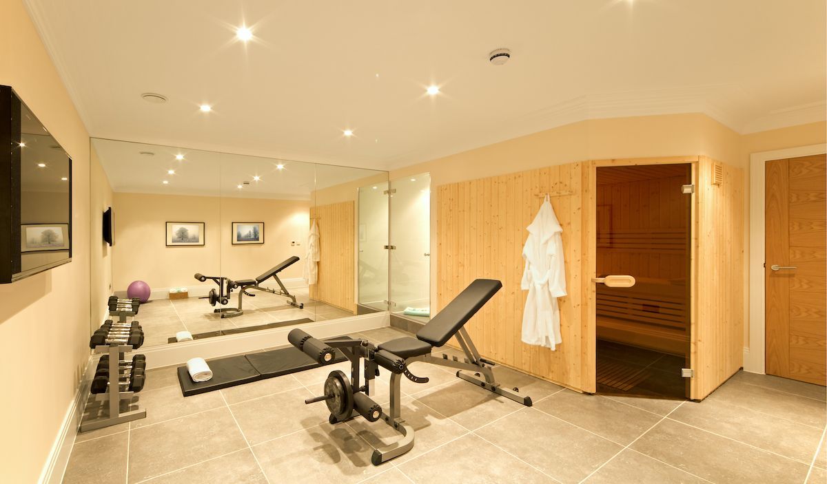 Warm colored home gym with spa area.