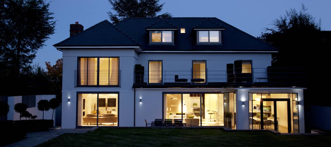 house at night with lights on inside without blinds