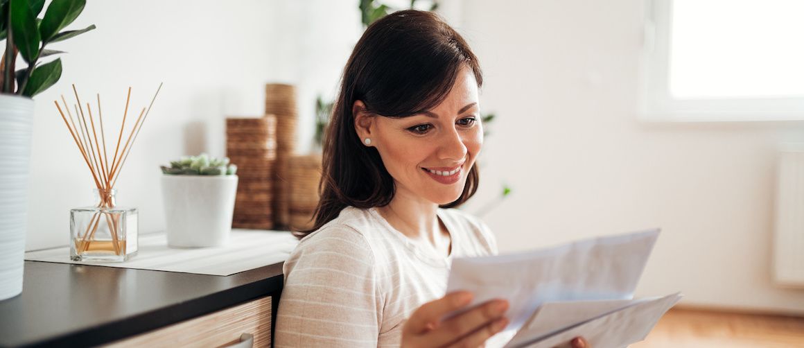 Woman viewing a snail mail letter.