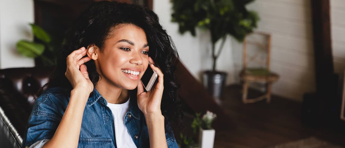 Young Woman On Phone With Attorney Discussing First Time Home Purchase