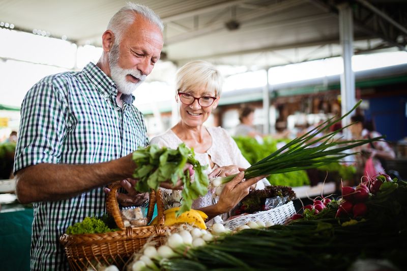 Senior couple picking out vegetables in a farmer's market in Iowa
