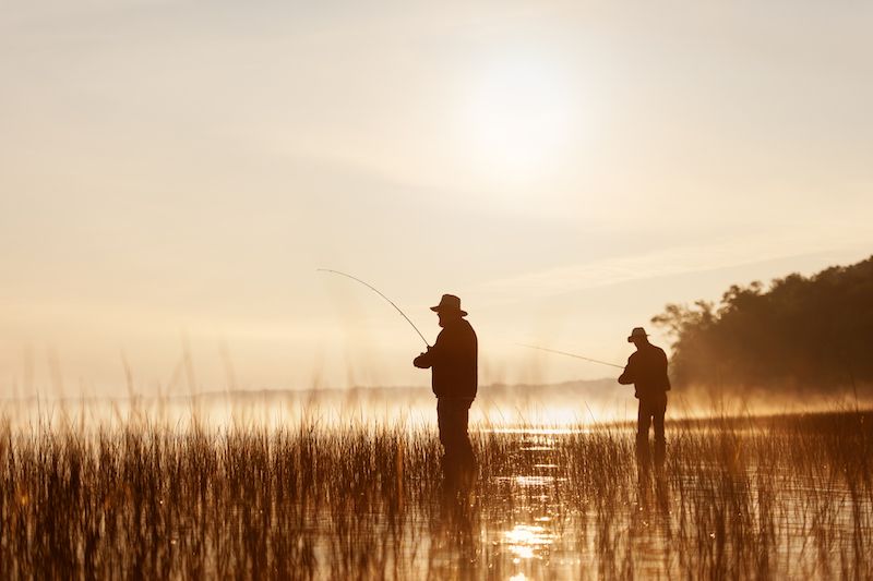 Senior men fishing in the swamplands of South Dakota