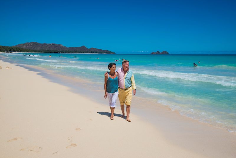 Elderly couple walking on the beach
