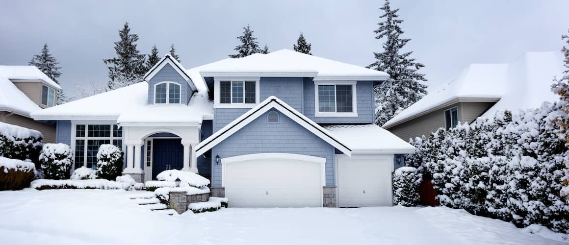 Snow covered grey suburban house