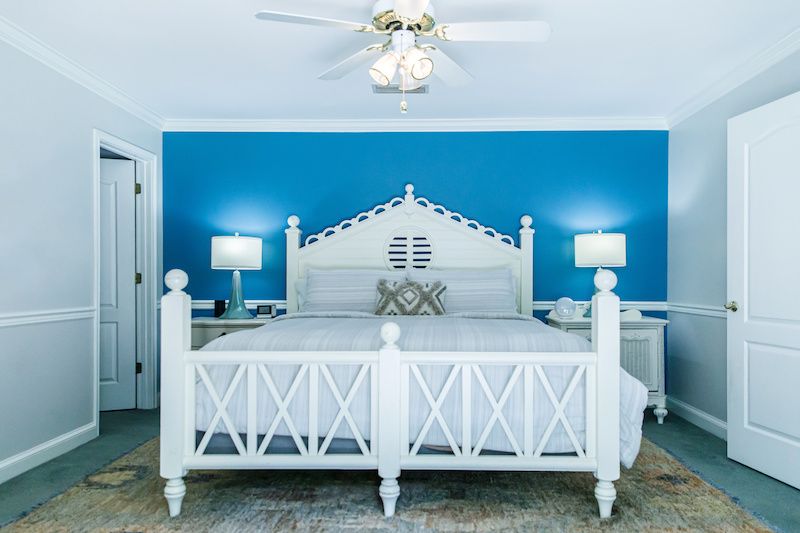 Bright blue accent wall in bedroom.