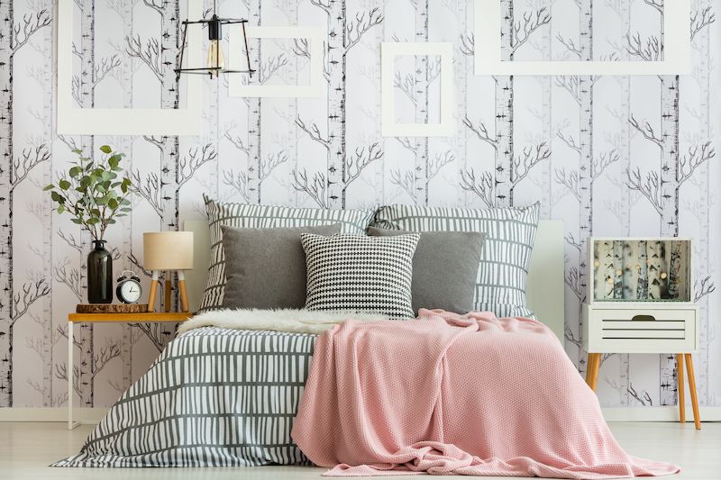 Bedroom with multiple patterns incorporated into decor.