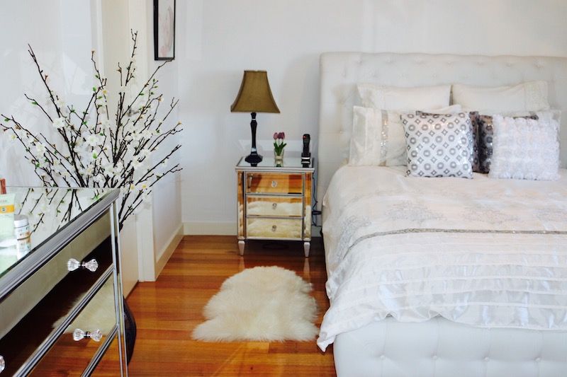 Mirrored dressers in a bedroom.