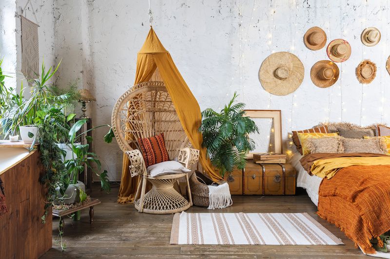 Bohemian Style Bedroom With Plants And Hanging Chair