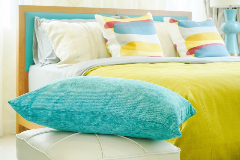 Bright colored pillows in a bedroom