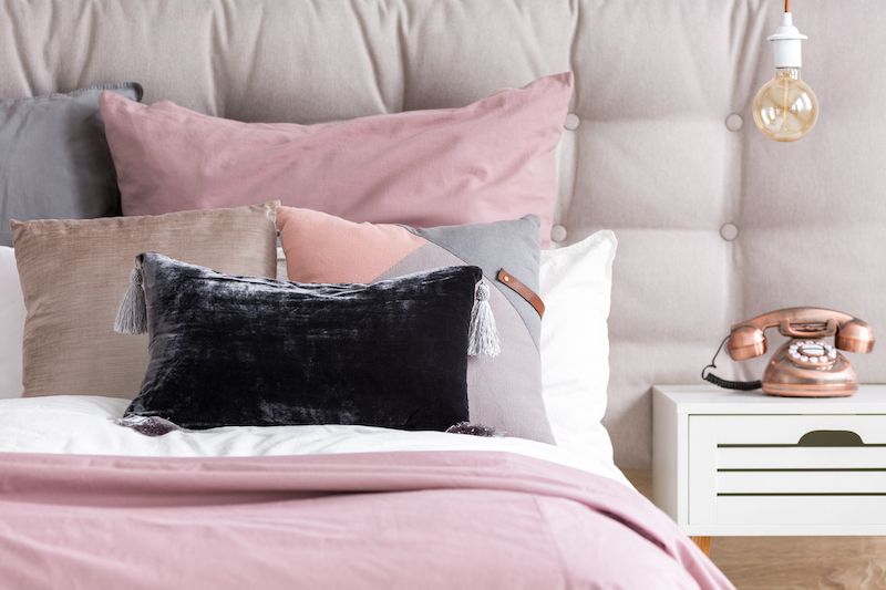Bed pillows and blankets with different textures.