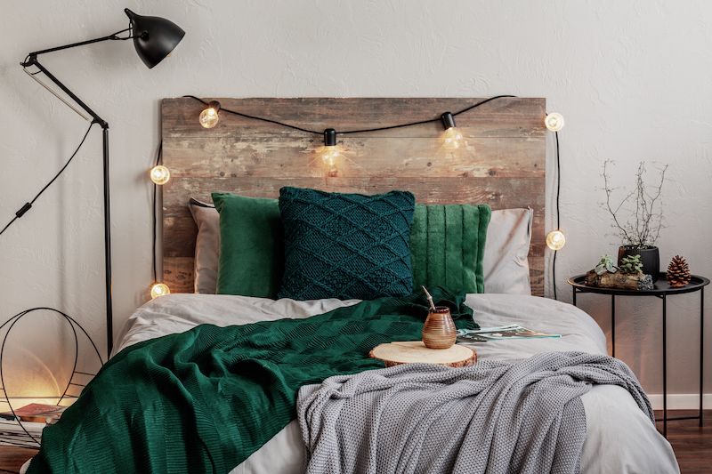 Rustic Wood headboard and bed with green decor.